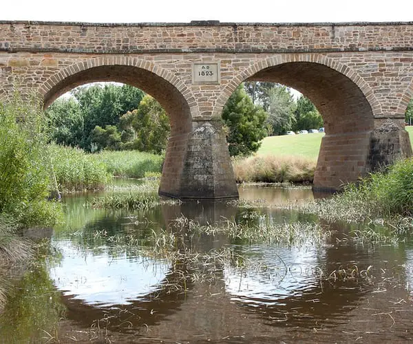 Richmond Bridge reflecting into the Coal River beneath it.